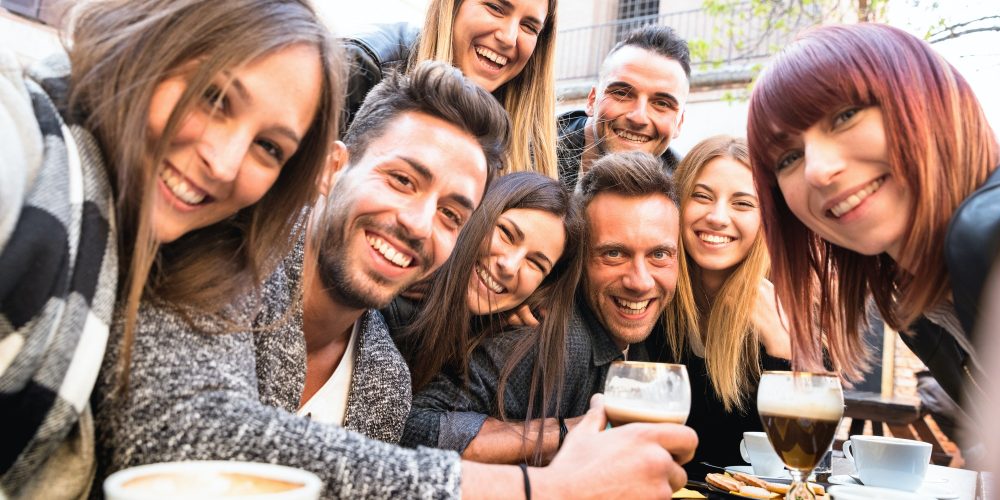 Friends taking selfie at bar restaurant drinking cappuccino and irish coffee