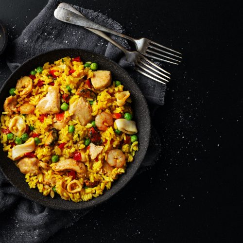 Spanish paella on plate on table